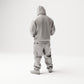 Stehende Figur: Person im Hip-Hop-Style mit Kapuzenjacke, Basecap & Gesichtstuch, Hände in den Taschen (B034) - Rueckansicht