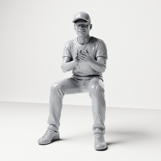 Diorama model-making product photo 0: Seated male spectator with cap and clasped hands (B068)