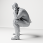 Diorama model-making product photo 7: Kneeling figure: crouching man in a hooded jacket with hand on face (a163)
